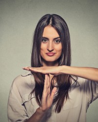 young, happy, smiling woman showing time out gesture