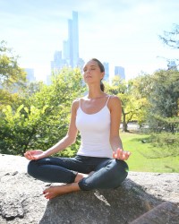 Woman doing yoga exercises in Central Park, NYC