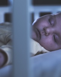 Baby sleep in a baby bed.