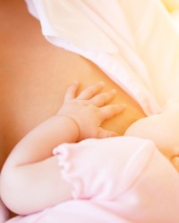 Mother nursing baby by breastfeeding